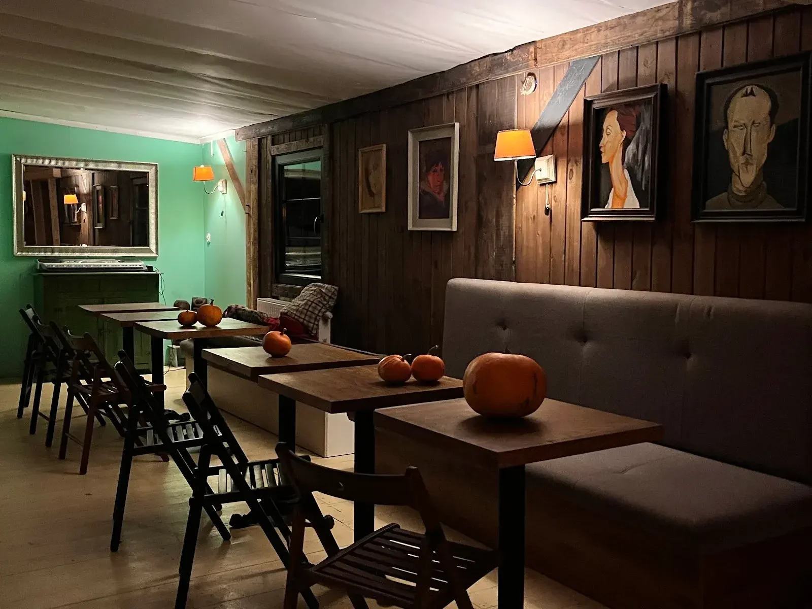 Mesa, pared verde, lámparas